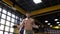 A handsome male boxer jumps on a skipping rope in a boxing gym.