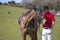 Handsome Male Horse Rider standing next to horse