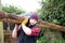 Handsome male lumberjack carries wood log on his shoulder