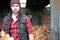 Handsome male lumberjack chops firewood in yard