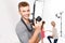 Handsome male photographer smiles while upholding