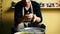 Handsome male potter knead clay before work in the pottery workshop