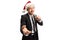 Handsome male singer in a black suit singing on a microphone and wearing a Santa Claus hat
