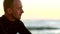 Handsome male surfer in a wetsuit by the beach. Mature man thinking while waiting for the current, tide and waves to