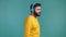Handsome man with beard listening to music with wireless headphones, guy having fun, dancing in studio on blue