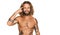 Handsome man with beard and long hair standing shirtless showing tattoos smiling pointing to head with one finger, great idea or