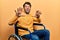 Handsome man with beard sitting on wheelchair afraid and terrified with fear expression stop gesture with hands, shouting in shock