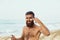 Handsome Man with beard, Sunbathing With Sunscreen Lotion Body In Summer. Male Fitness Model Tanning Using Solar Block Cream For H