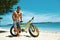 Handsome Man With Bike Sun Tanning On Beach. Summer Vacation.