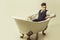 Handsome man or businessman relaxing in classic bath