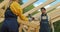 Handsome man carpenter giving electric drill to woman