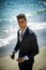 Handsome man in classical suit on beach