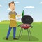 Handsome man cooking barbecue grill outdoors holding a bottle and tongs