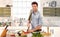 Handsome man cooking in kitchen at home