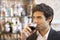 Handsome man drinking a glass of red wine in bar