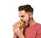 Handsome man eating tasty burger isolated