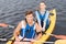 Handsome man enjoying sport activity while rowing in canoe