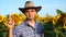 Handsome man farmer showing no sign in sunflowers field