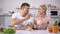 Handsome man feeding girlfriend with cake, date in kitchen, romantic atmosphere