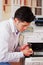 Handsome man fixing a photocopier during maintenance using a screwdriver