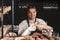 Handsome man with freshly baked bread working in bakery shop