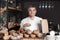 Handsome man with freshly baked bread working in bakery shop