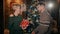 A handsome man is giving a happy girl a christmas present in their well-designed living room.