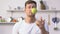 Handsome man having fun juggling apples in kitchen, talent, leisure activity