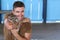 Handsome man holding a baby ocelot