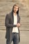 Handsome man with hood standing in urban city interior. informal style clothing. Fashionable young model man. Mystery