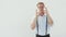 Handsome man in light shirt shows ok gesture on white background and smile