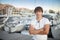 Handsome man by luxury yacht background on the beach at sunset.