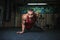 A handsome man with a muscular body on a blurred background. muscle man is doing a push-up in the gym. Sports
