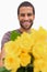 Handsome man offering bunch of yellow roses