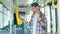 Handsome man is paying transport ticket with mobile phone.