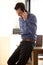 Handsome man on phone call leaning on desk