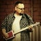 Handsome man playing his cigar box guitar