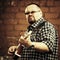 Handsome man playing his cigar box guitar