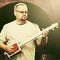 Handsome man playing his cigar box guitar