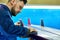 Handsome Man Polishing Cistom Surfing Board in Workshop