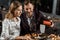 Handsome man pouring wine in glasses while couple having dinner