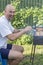 Handsome man preparing barbecue for friends