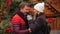 Handsome Man and Pretty Woman Drinking Coffee on Tradition Christmas Market. Wife and Husband Look at Each Other with