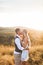 Handsome man and pretty woman in stylish boho rustic clothes, kissing. Lovely couple in eco boho rustic style, standing