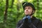 Handsome man putting his helmet on before cycling