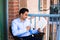 Handsome man reading on balcony