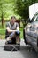 Handsome man repairing car outdoors