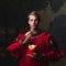 Handsome man in a Royal red doublet eating French fries.