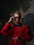 Handsome man in a Royal red doublet and sunglasses.