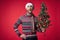 handsome man in a santa hat Christmas decorations holiday New Year studio posing